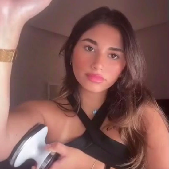 Model demonstrating EMS fat-reduction massager during home use