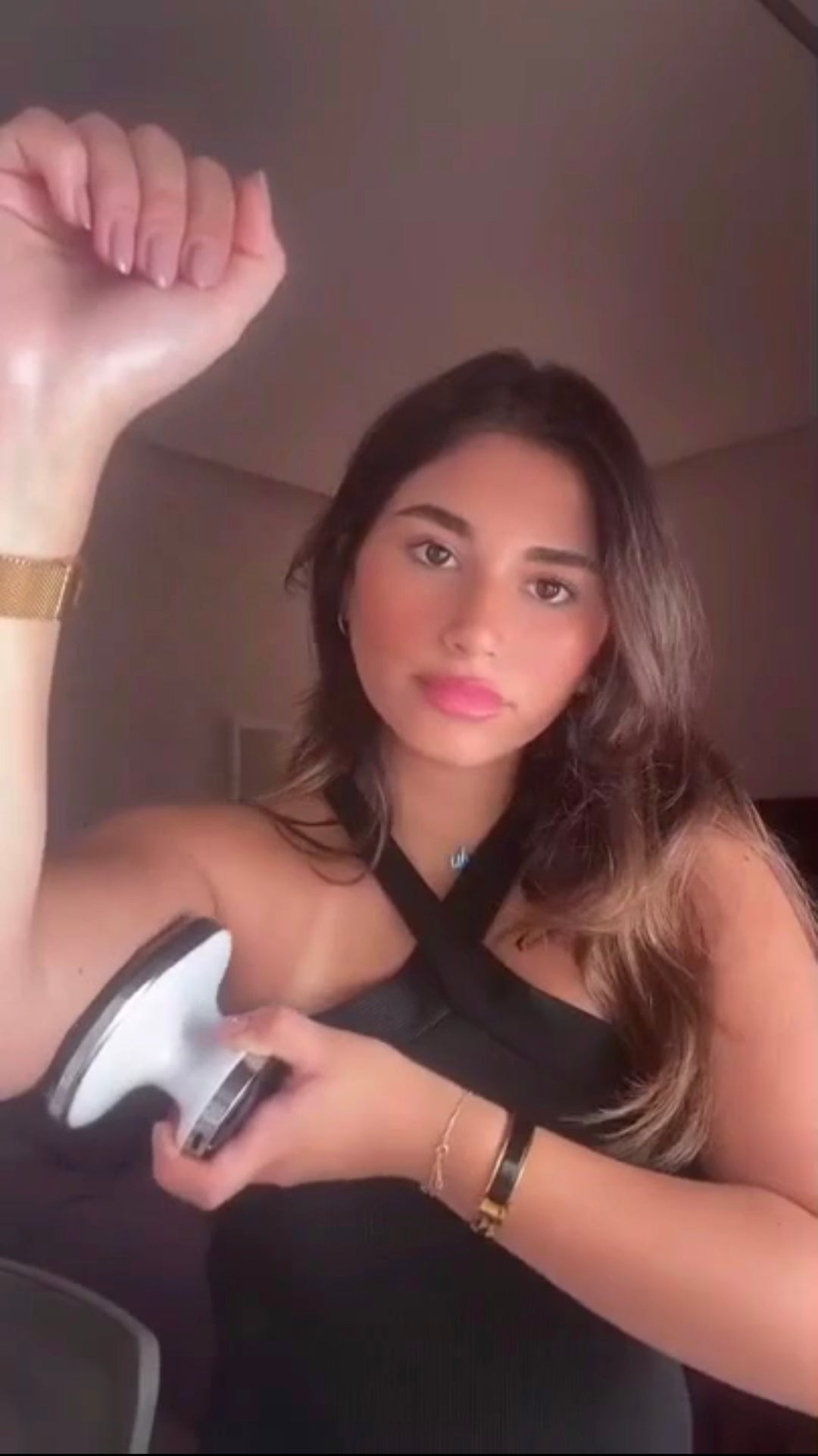 Model demonstrating EMS fat-reduction massager during home use